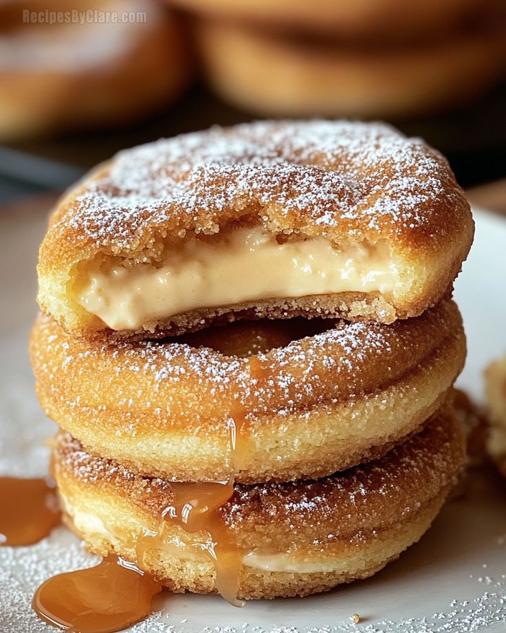 three donuts stacked on top of each other covered in icing and caramel