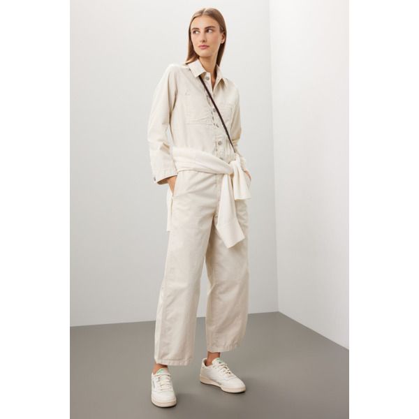 White denim (100% Cotton). Jumpsuit. Long sleeves. Collar. Front button closure. 53" from shoulder to hemline. 25.25" inseam. 19.75" leg opening. Imported. Collared Jumpsuits And Rompers With Pockets In Relaxed Fit, Wide Leg Cotton Overalls For Fall, Cotton Wide Leg Overalls For Fall, Cotton Jumpsuits And Rompers With Pockets For Work, Cotton Workwear Jumpsuits And Rompers With Pockets, Denim Workwear Jumpsuit With Buttoned Pockets, Denim Overall Jumpsuit With Buttoned Pockets For Work, Cotton Overall Outerwear For Work, Casual Collared Jumpsuits And Rompers For Work