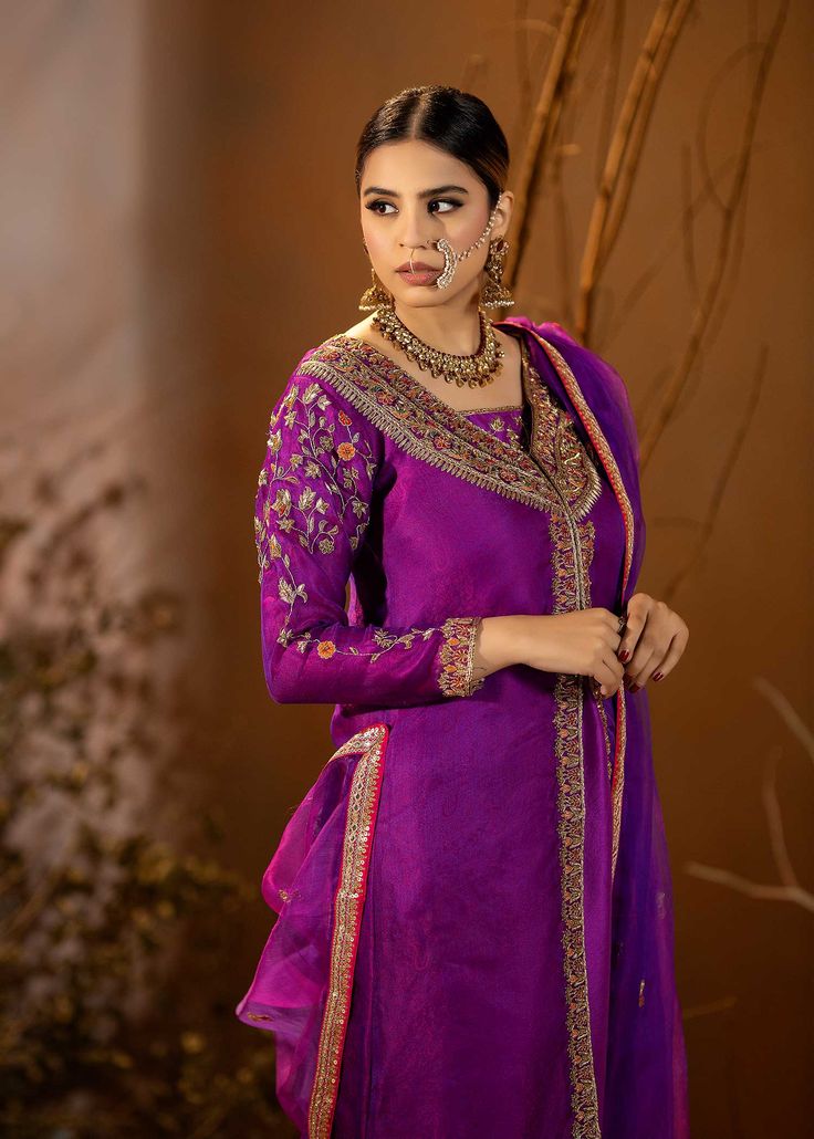 Introducing our stunning Purple Organza Outfit! This elegant dress is adorned with intricate details, featuring beautiful embroidery and embellishments. The rich purple color adds a regal touch, and it comes with a chooridar pajama for a complete look. Perfect for making a statement at special occasions! Purple Churidar With Intricate Embroidery, Purple Raw Silk Salwar Kameez For Festivals, Unstitched Purple Raw Silk Kurta, Festival Purple Raw Silk Salwar Kameez, Designer Raw Silk Purple Salwar Kameez, Designer Purple Raw Silk Salwar Kameez, Designer Wear Purple Raw Silk Salwar Kameez, Semi-stitched Purple Anarkali Unstitched Suit, Purple Chanderi Kurta With Mirror Work