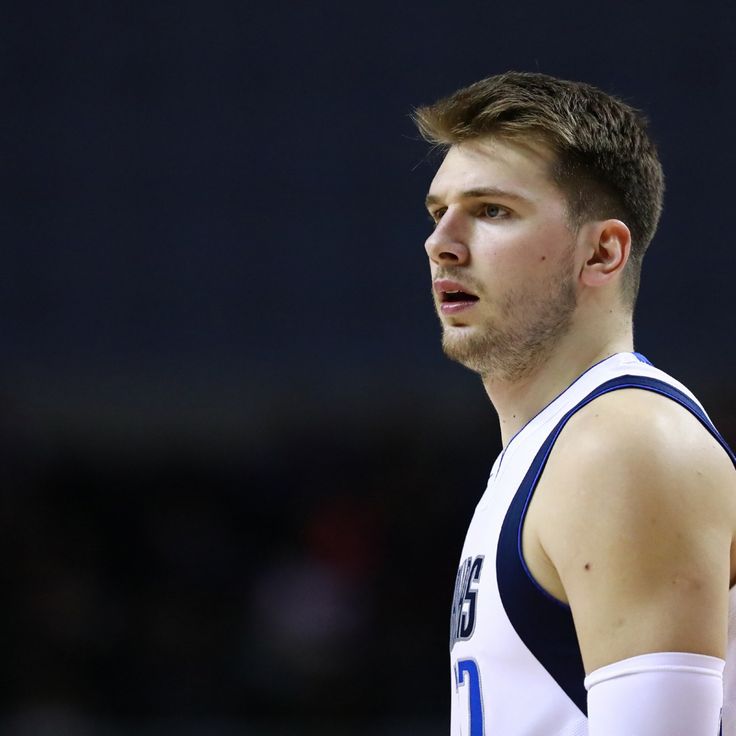 a male basketball player in a white and blue uniform