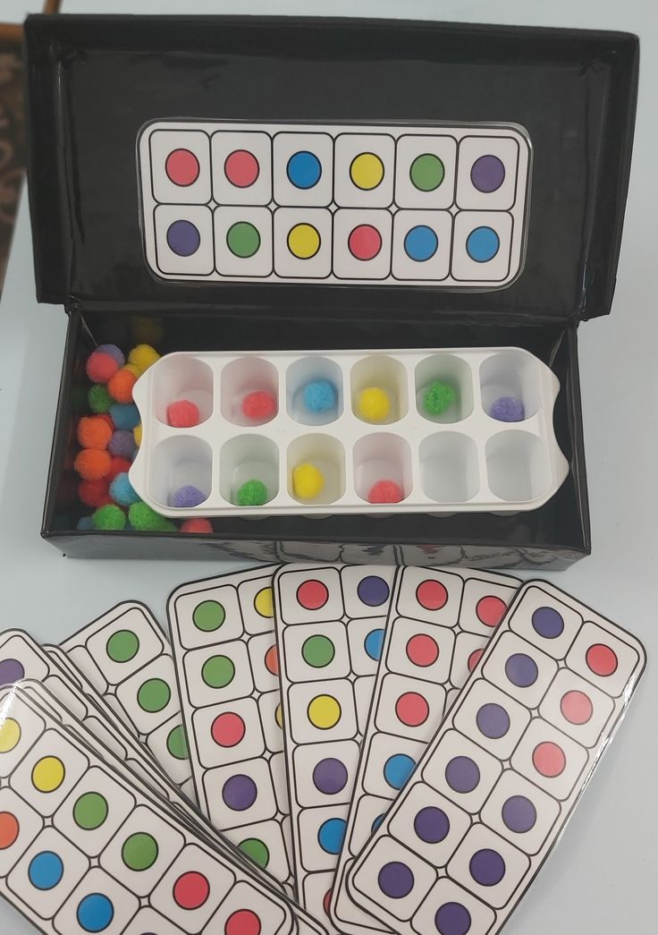 four matching cards in a black case with colored dots on them, and six empty ones