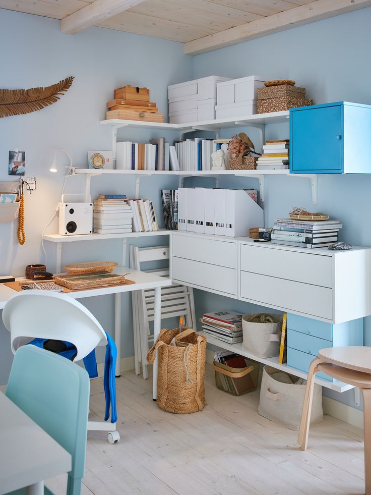 a room filled with lots of white furniture and bookshelves on top of shelves