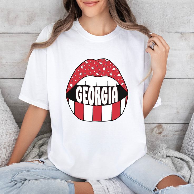 *Also available as a sweater. See below.* Welcome to the ultimate gameday wardrobe addition! This UGA Lips T-Shirt not only boasts trendy style, but also shows off your team spirit for UGA football. Stay cozy and stylish while supporting your favorite team. Go dawgs! White Game Day Fan Apparel T-shirt, White Fan Apparel T-shirt For Game Day, School Spirit T-shirt For Game Day, Relaxed Fit, White Relaxed Fit Sports Fan T-shirt, White Relaxed Fit T-shirt For Sports Fans, Collegiate T-shirt With Sublimation Print For Game Day, Sports Fan Tops With Sublimation Print For Game Day, White Sports Fan T-shirt Relaxed Fit, White Sublimation Design Fan Apparel For Game Day