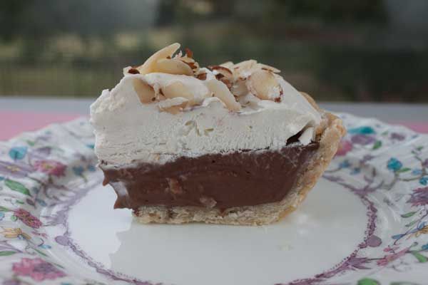 a piece of cake sitting on top of a white and blue tablecloth covered plate