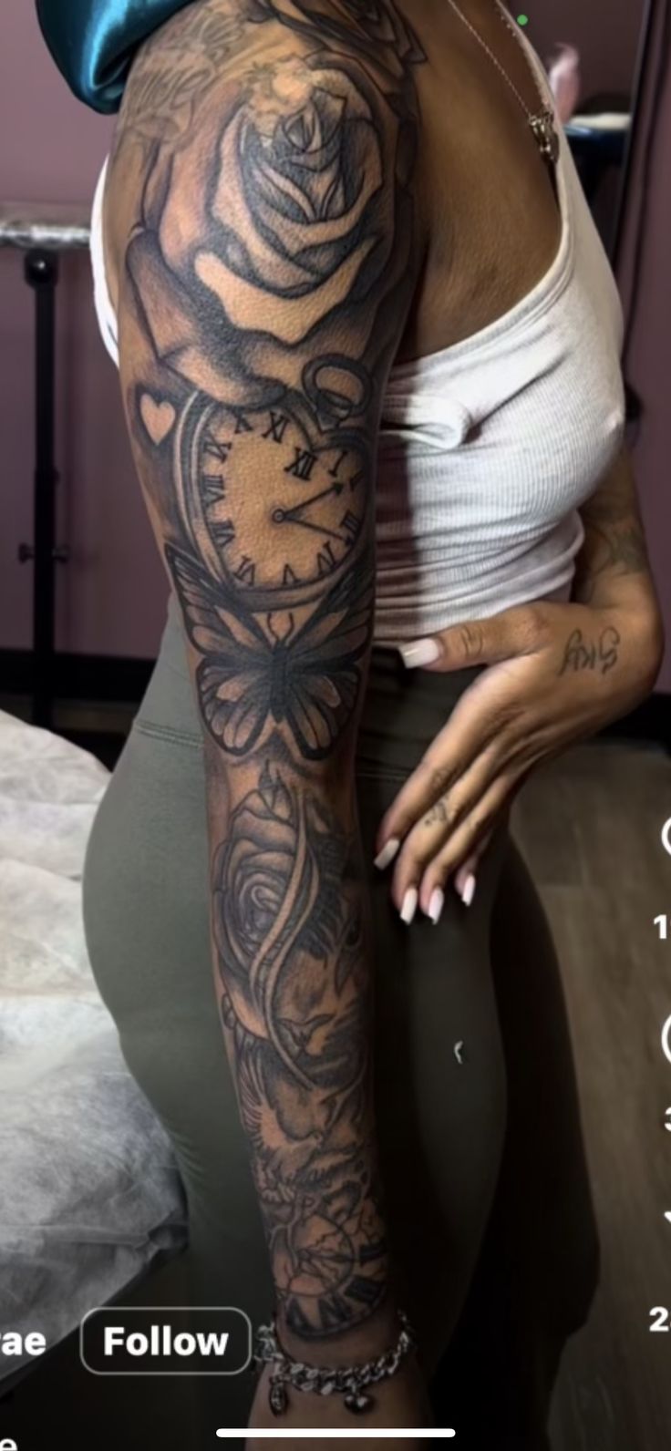 a woman with tattoos on her arm and leg