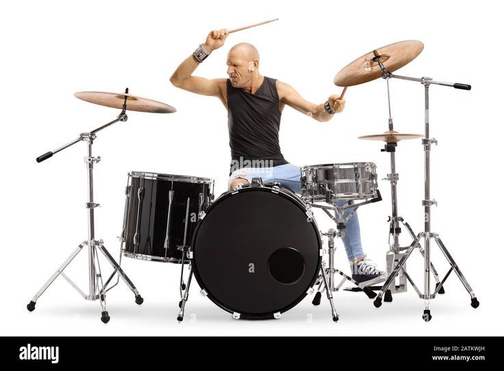 a man sitting on top of a drum set with his hands up in the air