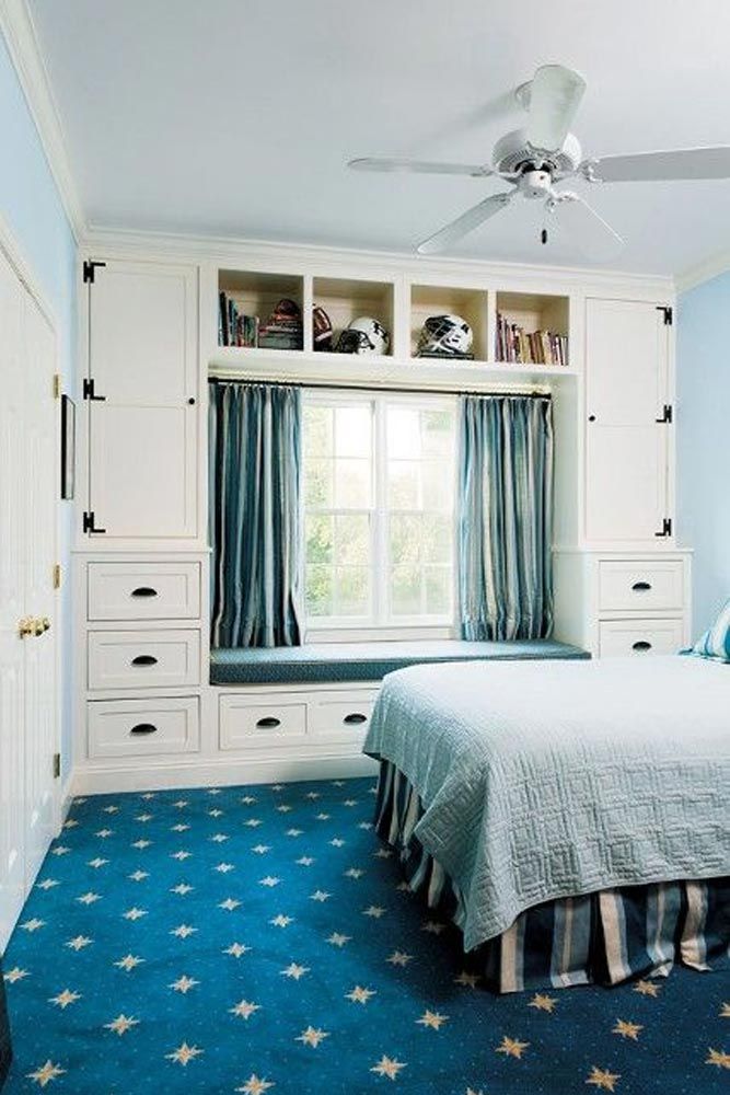 a bedroom with blue carpet and white walls