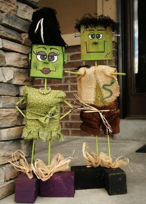 three scarecrows are standing in front of a brick wall