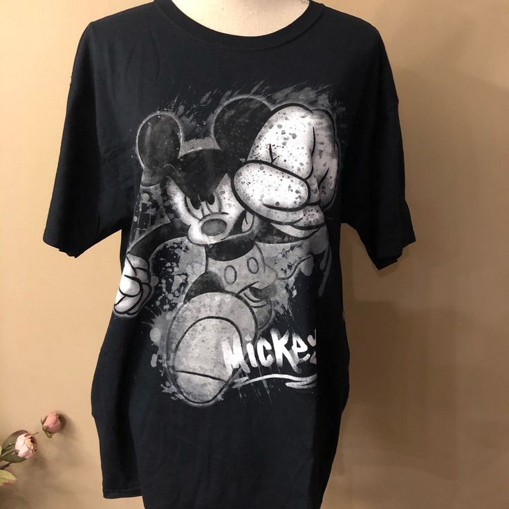 a black mickey mouse shirt hanging on a wall