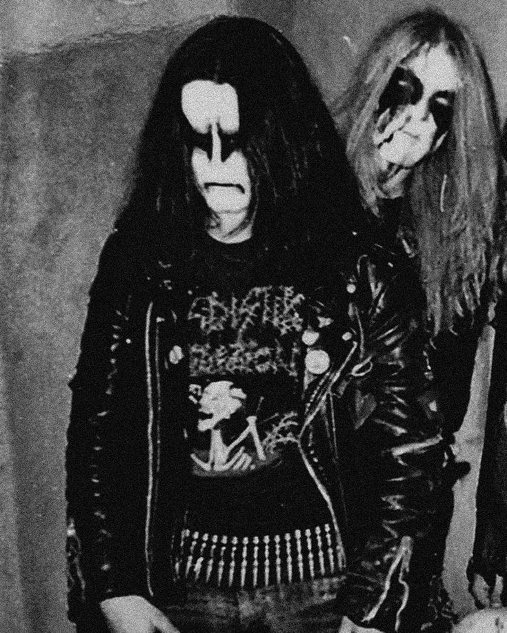 two men in black leather jackets standing next to each other with their faces painted on