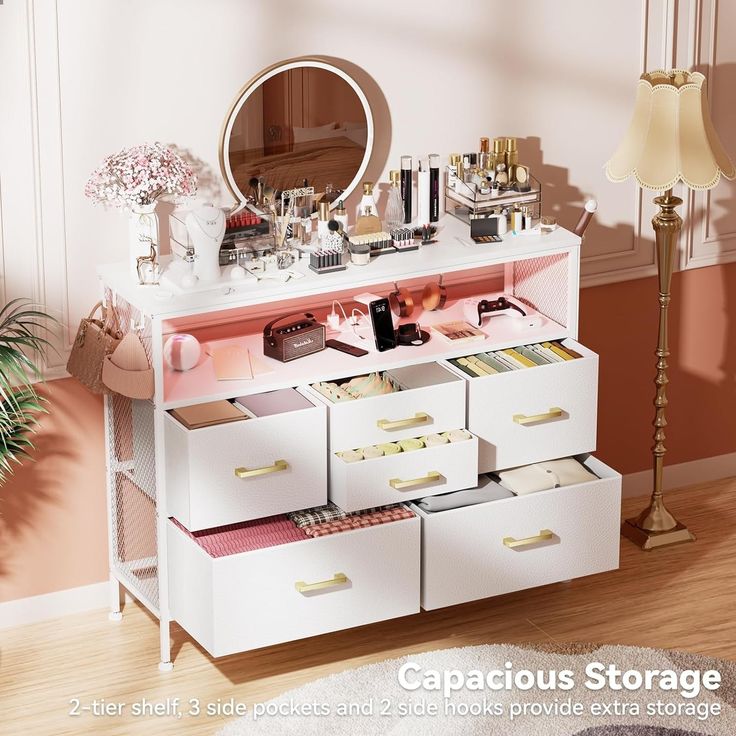 a white dresser with lots of drawers and makeup products on it's top shelf