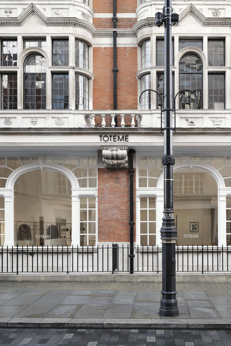 an empty street corner with a lamp post and storefront