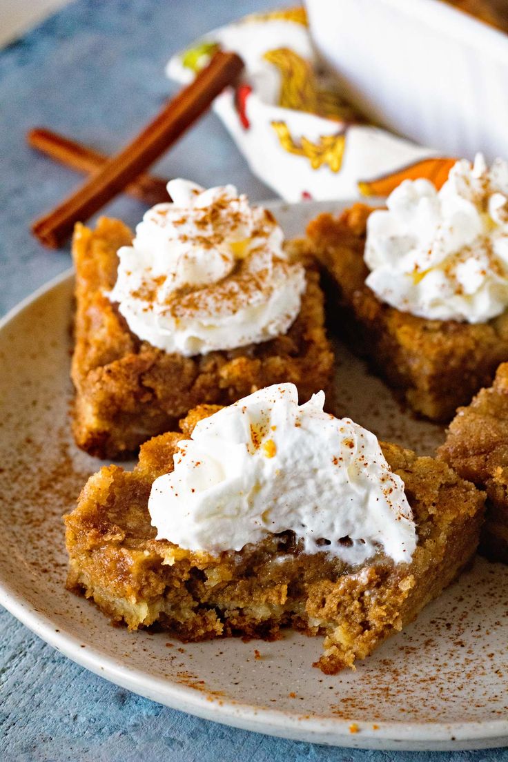 there are several desserts on the plate with cinnamon sticks