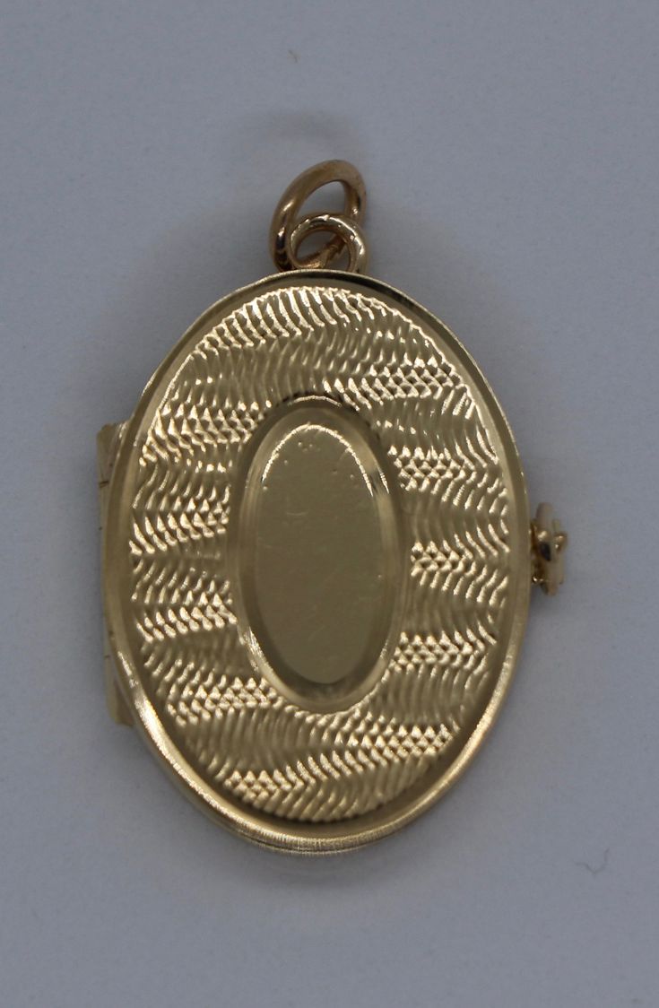 This hand-made oval locket is as sentimental as it gets. It is a beautiful holiday present. It is both beautiful and functional. Most lockets can hold 2 pictures but this one can hold 4 special photos close to your, or your loved one's, heart! It also has room to be personalized with an initial monogram. It is hard to match the workmanship of this locket. It was crafted by a very talented jeweler in the NYC jewelry district between 1970 - 1980. Lockets are his legacy and his remaining inventory Luxury Yellow Gold Oval Locket Necklace, Luxury Oval Locket Necklace As Gift, Timeless Engraved Oval Locket Necklace, Timeless Oval Engraved Locket Necklace, Timeless Oval Locket Necklace, Timeless Yellow Gold Oval Locket Necklace, Timeless Gold Oval Locket Necklace, Timeless Oval Yellow Gold Locket Necklace, Luxury Engraved Oval Locket Necklace