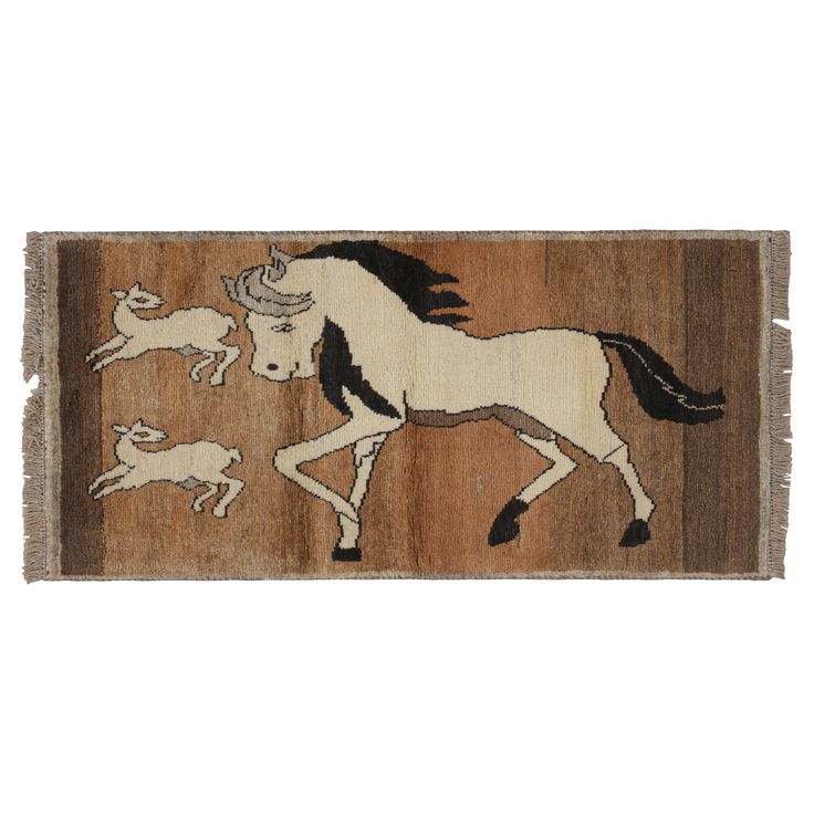 a rug with an image of a horse and two dogs on it