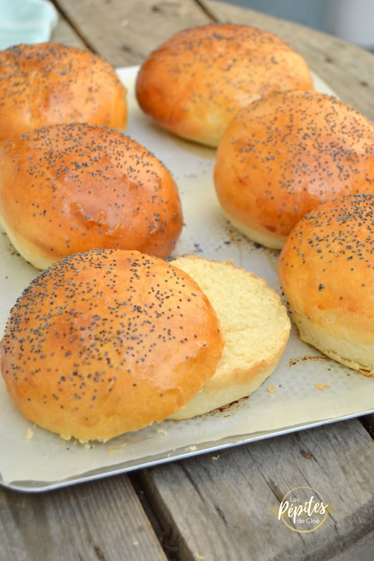 bread rolls with poppy seed sprinkles on a tray