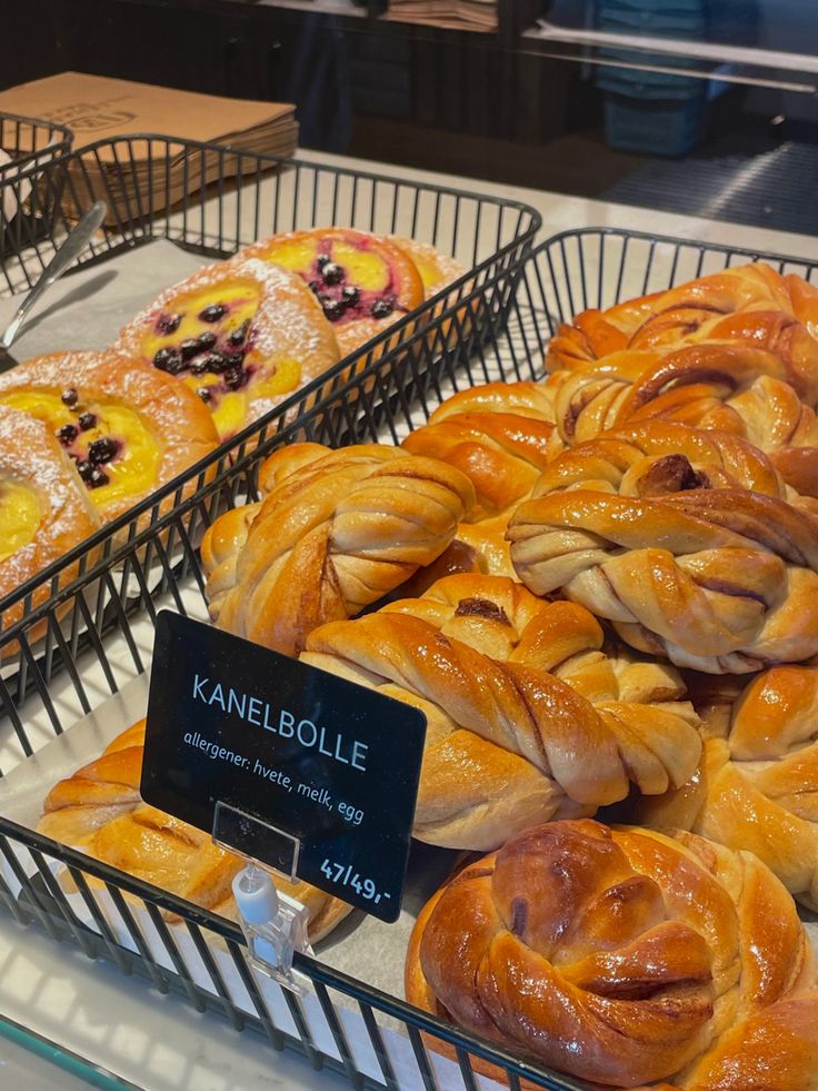 many different types of pastries on display in a bakery