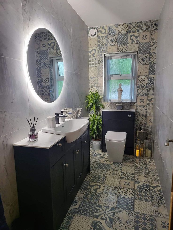 Full strip out and refurb of old cloakroom into a tranquil downstairs toilet. Blue,.grey, white mixed fleur-de-lis mosaic tiles on the floor followed through as a feature window wall. Large marble effect tiles on the remaining walls. Finished with marble and matt black accessories, large, medium, and small lanterns with real yuca plant. Large Cloakroom Toilet Ideas, Large Downstairs Toilet Ideas, Yuca Plant, Toilet Ideas, Cloakroom Toilet, Marble Effect Tiles, Small Toilet Room, Downstairs Loo, Mosaic Bathroom