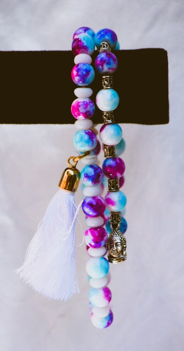 Bright and colorful! This bracelet will help brighten up anyone’s day. Pink beaded bracelet with charm and tassel. Colorful Adjustable Spiritual Beaded Bracelets, Bohemian Multicolor Charm Bracelet With 8mm Beads, Colorful Beaded Spiritual Bracelets, White Spiritual Friendship Bracelets With Colorful Beads, Colorful Adjustable Beaded Bracelets With 8mm Beads, Multicolor Crystal Bracelet With Spacer Beads For Healing, Bohemian Stretch Bracelet With Colorful Beads For Meditation, Multicolor Beaded Spiritual Crystal Bracelet, Spiritual Festival Bracelets With Spacer Beads