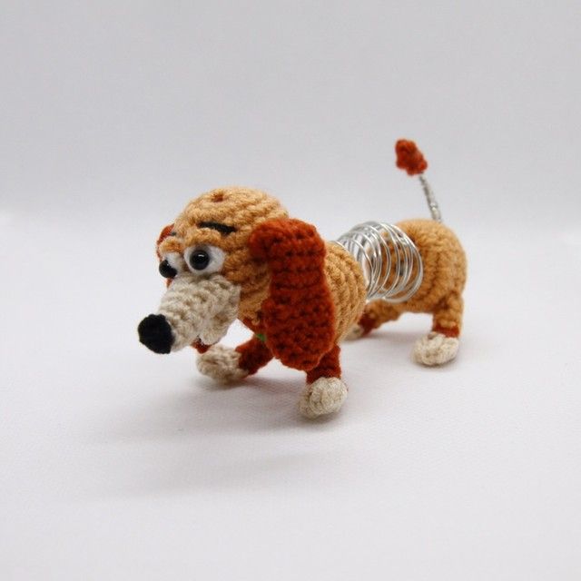 a small crocheted dog is standing on its hind legs