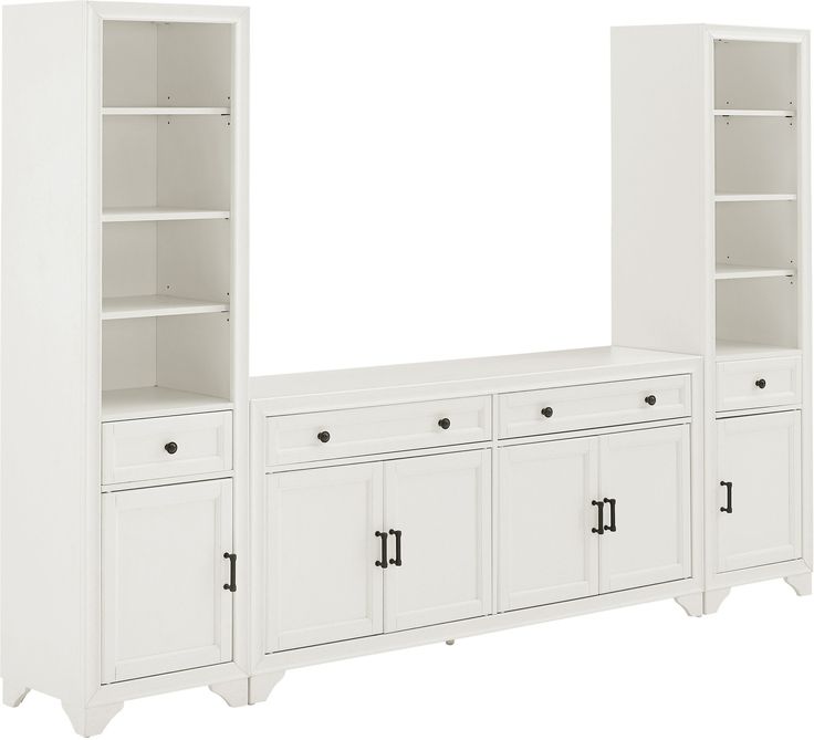 a white entertainment center with cabinets and drawers