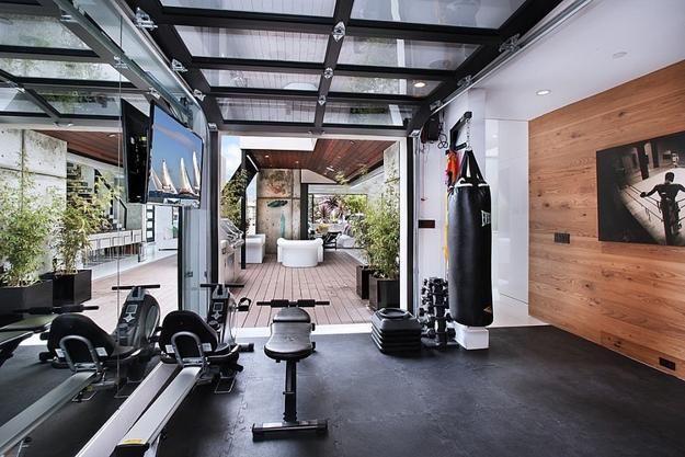 a home gym with exercise equipment and mirrors