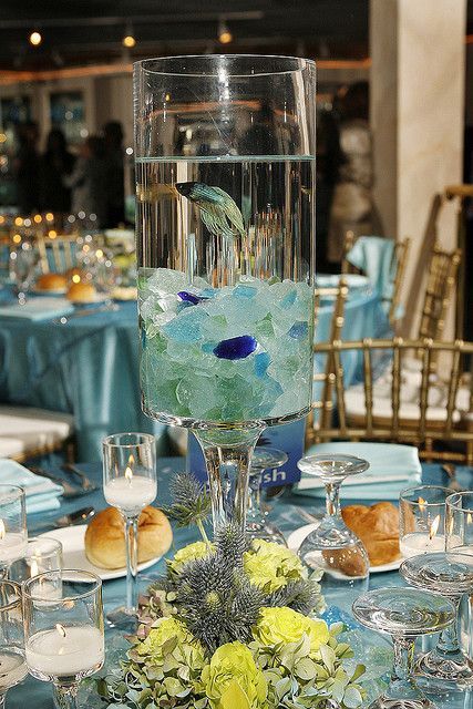 the centerpiece is made up of glass and flowers