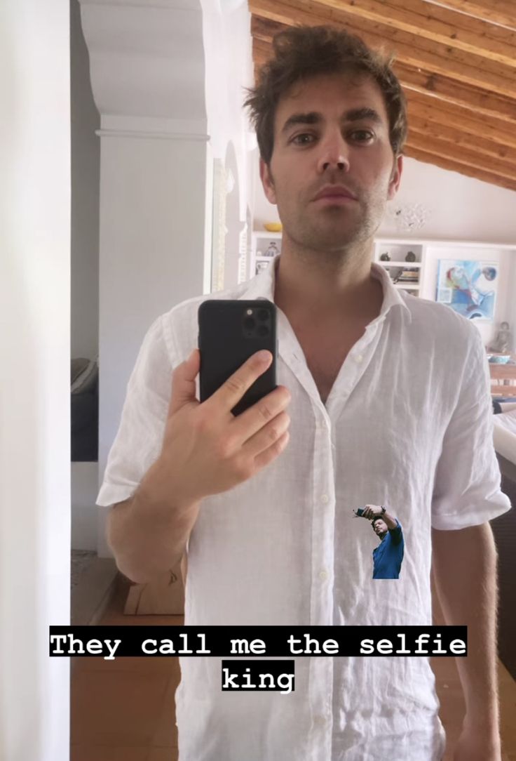 a man is taking a selfie in the mirror with his cell phone while wearing a white shirt