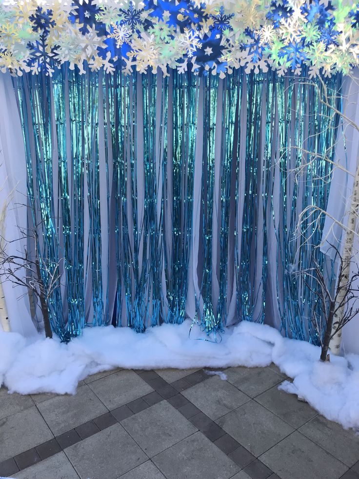 the backdrop is decorated with blue and white flowers, branches, and snowflakes