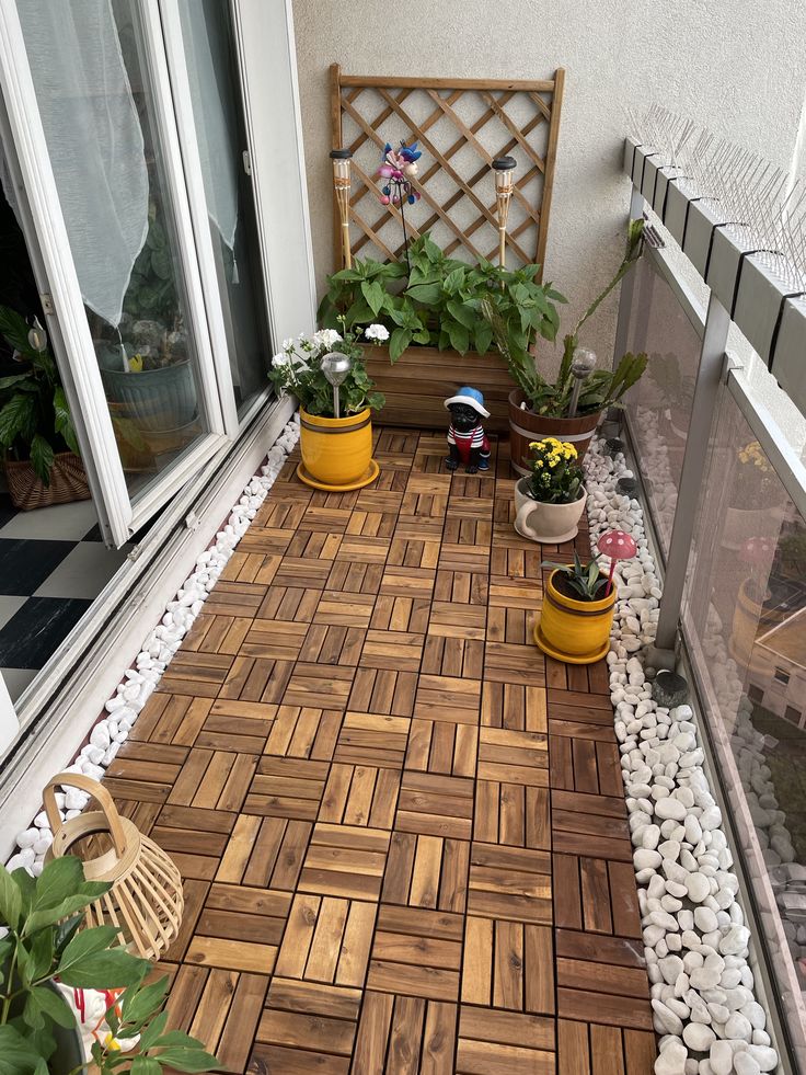 some plants are sitting in yellow pots on the outside of a house window sill