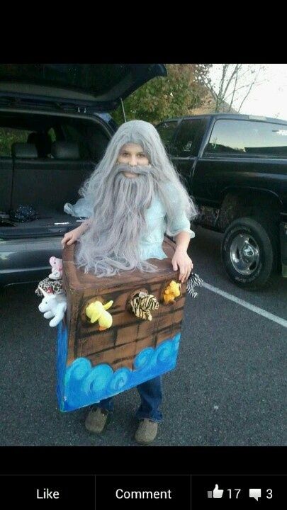 a man dressed up like an old pirate with a beard and long gray hair holding a trunk