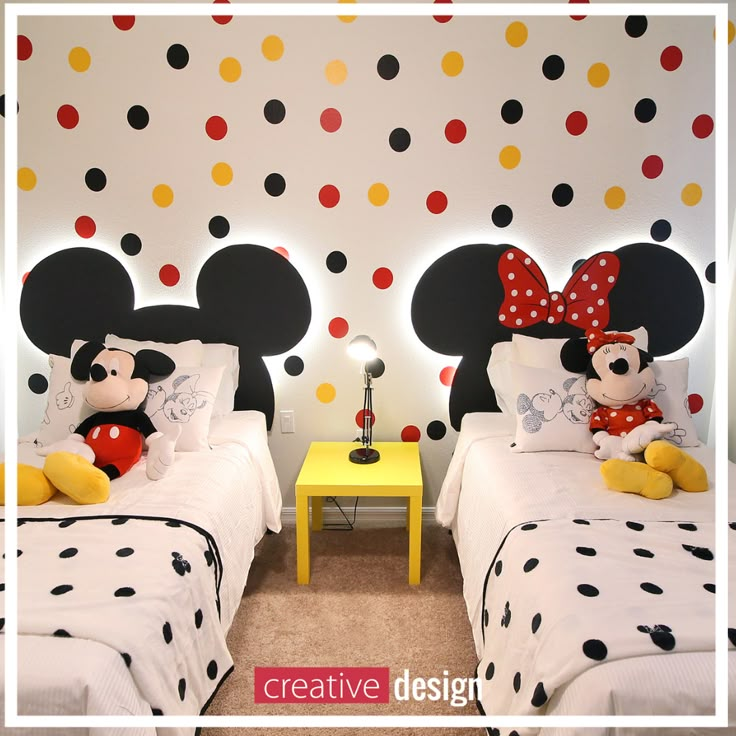 two beds with mickey and minnie mouse head heads on the wall next to each other