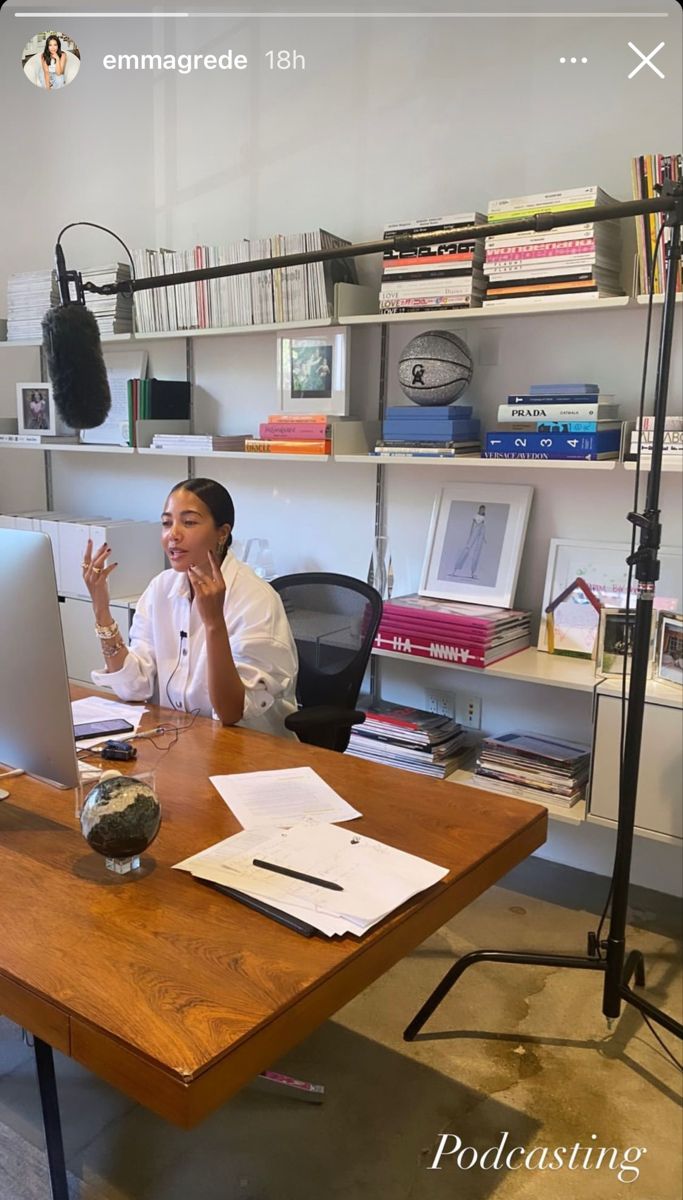 a woman sitting at a desk in front of a computer