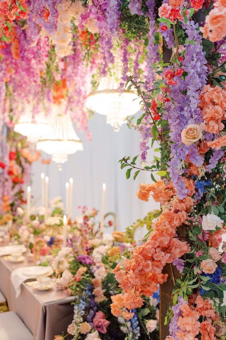 an arrangement of flowers and greenery decorates the dining room