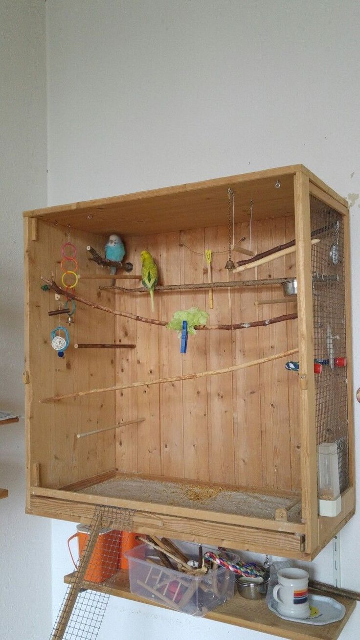 a wooden shelf with many different items on it and some wires attached to the wall