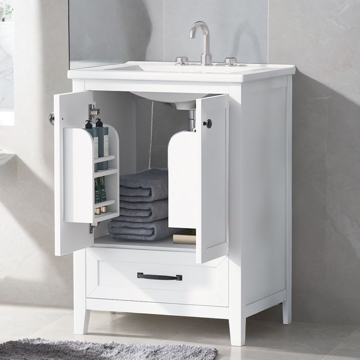 a white bathroom vanity with open cabinet and mirror