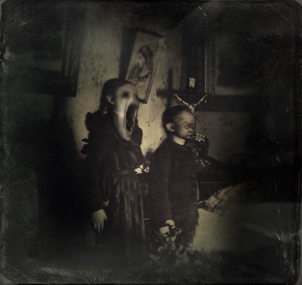 two young children standing next to each other in an old fashioned photo, one is holding the hand of another child