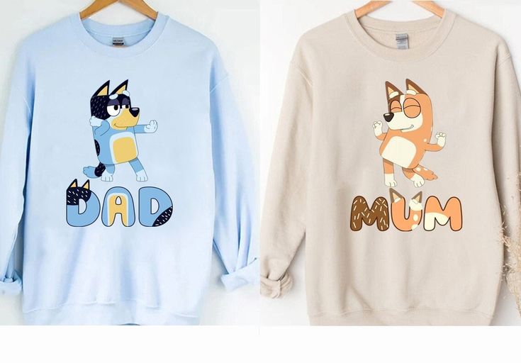 two sweatshirts with the words dad and cat on them, one has an image of a dog