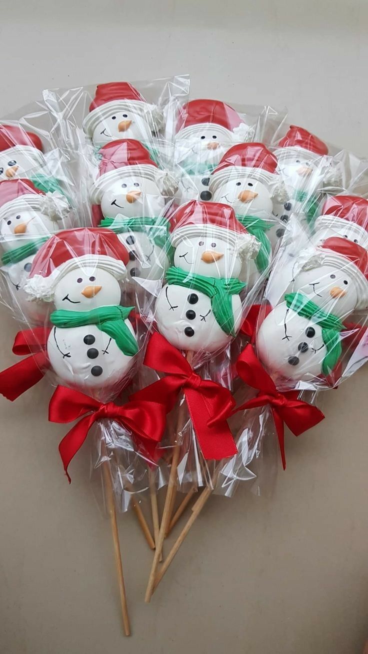 a bunch of snowmen sitting on top of each other in plastic wrappers with red bows