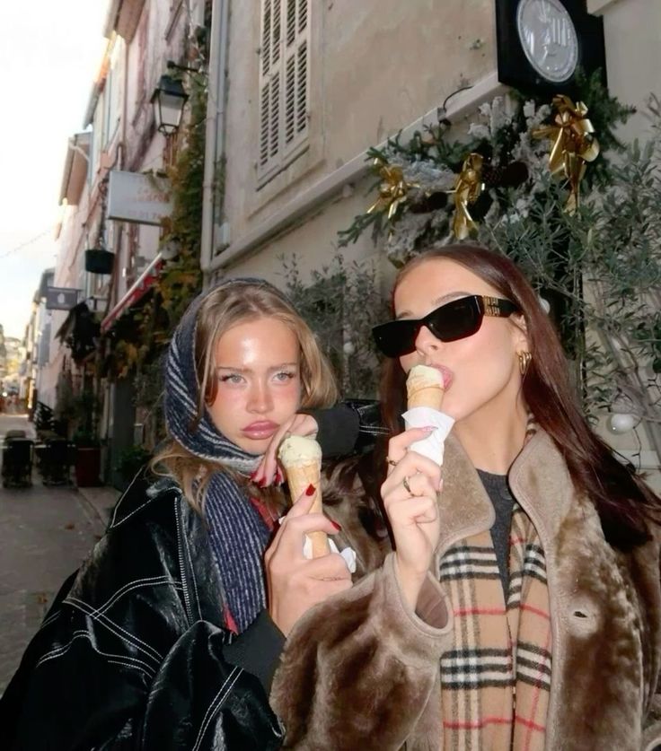 two women eating ice cream on the street