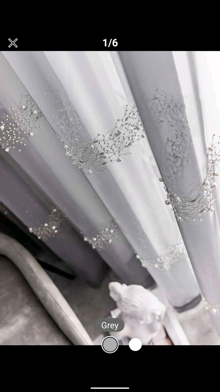 white sheer curtains with silver beading on them