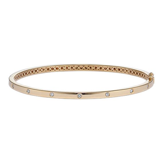 Natural diamonds in a stylish flush setting dot this bangle bracelet with beautiful sparkle. Crafted in warm 14-karat yellow gold  it has a tongue clasp with a safety lock for extra security. It makes a special gift or a classic addition to your own jewelry collection. Classic Yellow Gold Bangle With Diamond Accents, Classic Gold Bangle Bracelet With Diamond Accents, Everyday Hand Set Yellow Gold Diamond Bracelet, Classic Gold Bracelet With Diamonds, Stackable, Classic Stackable Gold Bracelet With Diamonds, Classic Gold Diamond Stackable Bracelet, Gold Bracelet With Diamond Accents, Classic Diamond Bangle Bracelet With Bezel Setting, Yellow Gold Bangle Diamond Bracelet With Bezel Setting