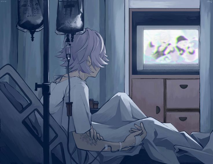 a person laying in a hospital bed watching tv