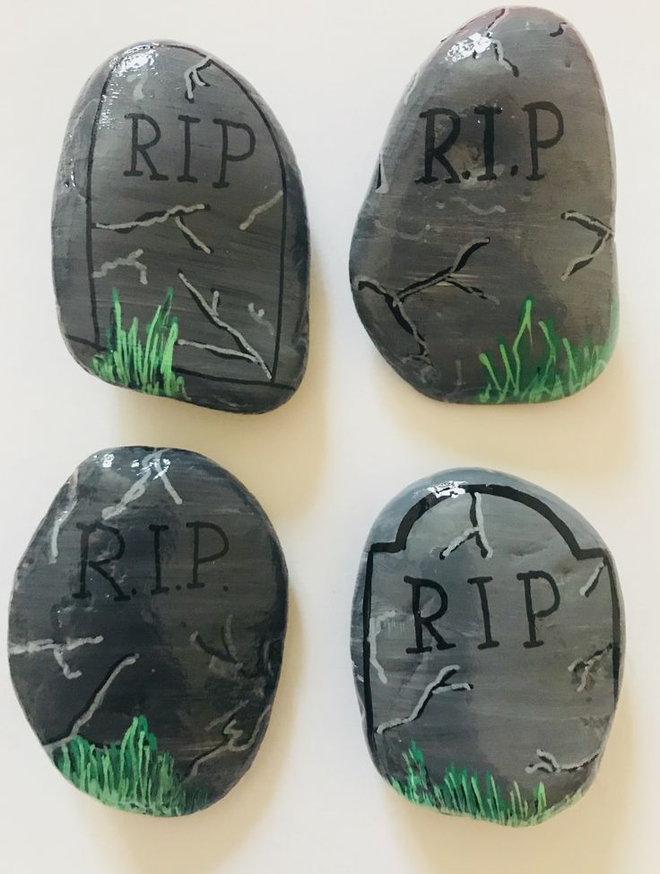 three painted rocks with the words rip on them and grass growing in between one rock