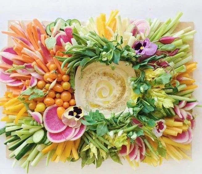 an arrangement of flowers arranged in the shape of a bowl