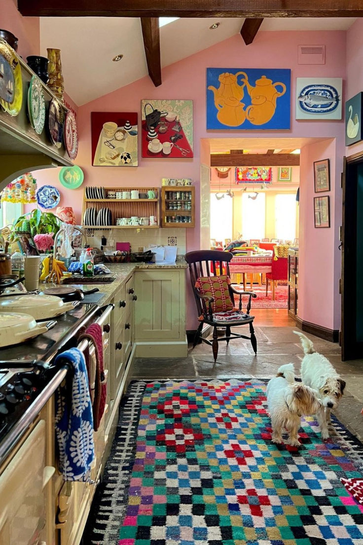 a dog is standing in the middle of a kitchen with colorful rugs on the floor