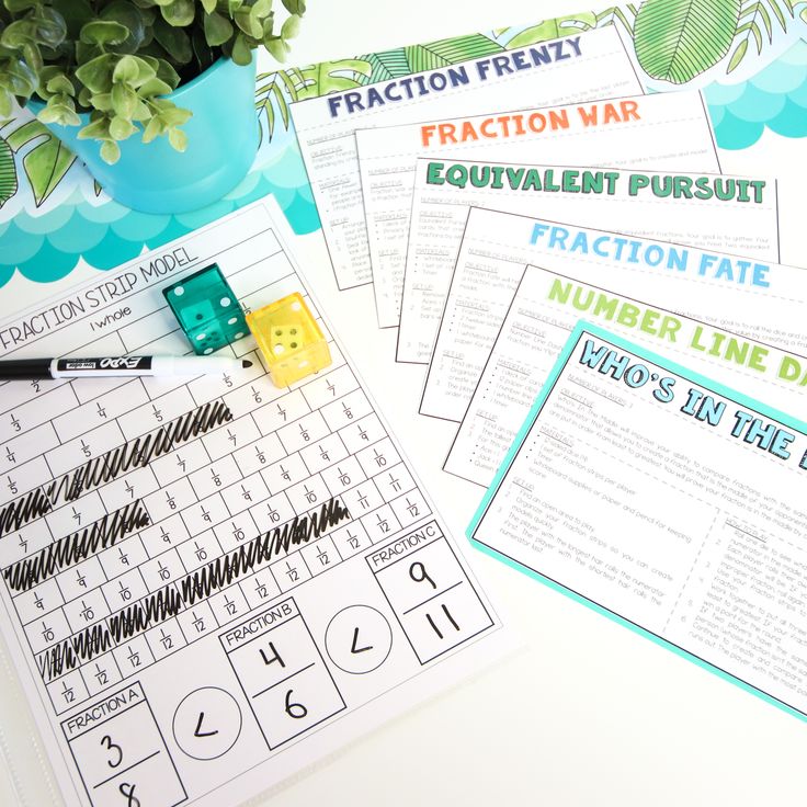 fraction line worksheets and numbers on a table with plants, pencils and markers