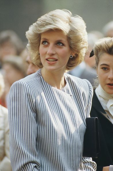 two women standing next to each other in front of a crowd