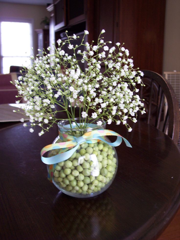 a vase filled with white flowers on top of a table