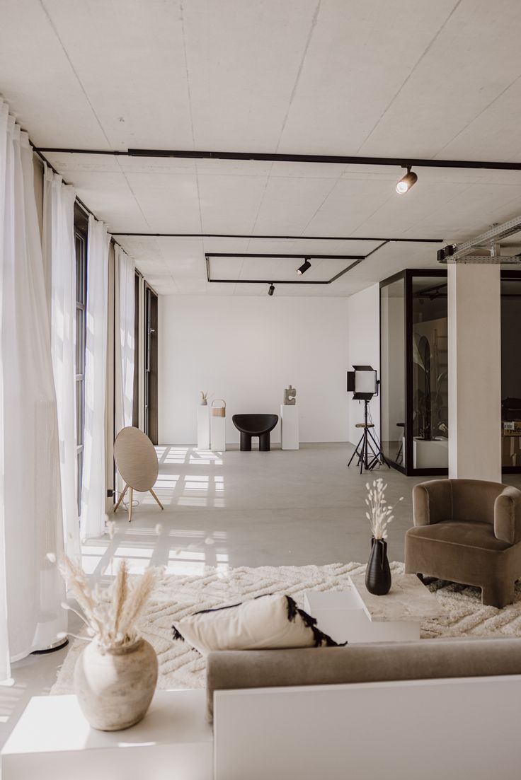 a living room filled with furniture and white walls